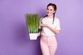 Photo o nice pretty young woman display hand pot grass smile good mood isolated on violet color background