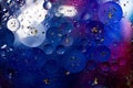 Oil on a water surface with bubbles and pieces of Gold leaf. Abstract colorful background. Close-up, not illustration Royalty Free Stock Photo