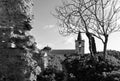 The old walls of the fortress with a leafless tree and an old church walls in black and white Royalty Free Stock Photo
