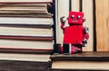 Photo of old antique books stack and row with robot