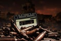 Photo of an old audio tape cassette on pile of bullets Royalty Free Stock Photo