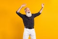 Photo of old cool funny funky man look empty space dance enjoy isolated on shine yellow color background