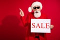 Photo of old grey haired retired pensioner man point finger empty space sale card xmas isolated on red color background Royalty Free Stock Photo