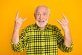 Photo of old man happy positive smile show fingers rock sign music lover horn isolated over yellow color background