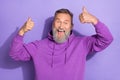 Photo of old pensioner aged bearded grandfather showing thumbs up like feedback crazy recommend isolated on purple color