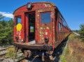 A photo of an old red train railway car with the door open, side view, rusted and weather-worn Royalty Free Stock Photo