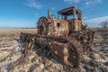 A photo of an old, rusty plowing machine with metal chains and wooden structures lying on the ground in front of it. the back Royalty Free Stock Photo