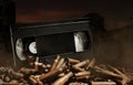 Photo of an old video tape cassette on pile of bullets Royalty Free Stock Photo