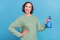 Photo of old white hair funky lady water flower wear green jumper isolated on blue color background Royalty Free Stock Photo