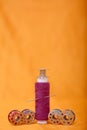 Photo of one pink sewing thread and bobbins Royalty Free Stock Photo