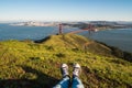 Photo of one`s feet in the park on a sunny day by the Golden Gate Bridge in San Francisco