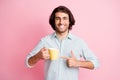Photo of optimistic cheerful brown hair guy pointing cup wear spectacles blue shirt isolated on pastel pink color