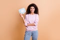 Photo of optimistic curly girl show like wear sweater jeans isolated on peach color background