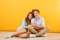 Photo of optimistic happy couple man and woman 20s smiling and h