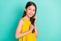 Photo of optimistic nice brown hair girl hands hair wear yellow dress isolated on bright teal color background