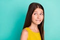 Photo of optimistic nice brown hair girl look empty space wear yellow dress isolated on bright teal color background Royalty Free Stock Photo