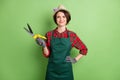 Photo of optimistic nice short brown hair lady hold pliers wear cap shirt isolated on pastel green color background Royalty Free Stock Photo