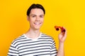 Photo of optimistic smart student with stylish hairdo dressed striped t-shirt hold retro binoculars isolated on yellow Royalty Free Stock Photo