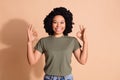 Photo of optimistic woman with perming coiffure wear khaki t-shirt showing okey approve nice work isolated on beige Royalty Free Stock Photo