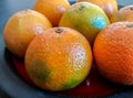 Clementines on orange ceramic plate