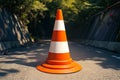 Photo Orange and white street cone against natural background, caution symbol