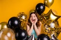 Photo of overjoyed lady yelling gladly surrounded by many balloons wear tank-top isolated yellow background Royalty Free Stock Photo