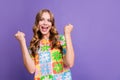 Photo of overjoyed satisfied woman with wavy hair wear print t-shirt clenching fists scream win bet isolated on purple Royalty Free Stock Photo