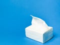 Photo a pack of white tissue against blue background.