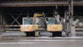 Photo of a Pair of Excavators Parked in an Industrial Area