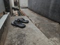 a photo of a pair of flip-flops in front of the door of an old house Royalty Free Stock Photo