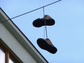 Pair of shoes hanging on the wire Royalty Free Stock Photo