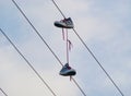 Pair of shoes hanging on the wire Royalty Free Stock Photo