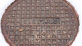 Photo Panorama frame Rusty circular utility electric manhole cover amid fresh white snow in winter Royalty Free Stock Photo