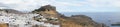 Photo panorama. View of the white buildings of Captains houses and the ancient Acropolis of Lindos in August. Royalty Free Stock Photo