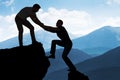 Man Assisting Male Friend In Climbing Rock Royalty Free Stock Photo