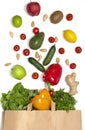 Photo of paper bag with vegetables and fruits. Flat lay composition with fresh vegetables on white background.