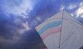 photo of paper kite with cloudy sky background.