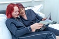 Photo of parent with teenagers. The candid portrait of a mature mother with his teenage daughter. a photo of a grandmother reading Royalty Free Stock Photo