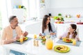 Photo of peaceful friendly cheerful family sit eat homemade food laugh good mood kitchen table apartment inside Royalty Free Stock Photo