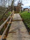 pedestrian wooden stairs, tree leaves on footbridge, autumn day