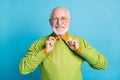 Photo of pensioner grandpa hands hold collar look camera wear specs green sweater isolated blue color background