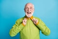 Photo of pensioner grandpa hands hold collar open mouth wear eyeglasses green sweater isolated blue color background