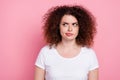 Photo of pensive woman with perming coiffure dressed white t-shirt look at proposition empty space isolated on pink Royalty Free Stock Photo