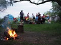 Photo of people camping. bonfire in the foreground
