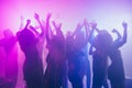 Photo of people charming girls dance raise hands party in neon light wear stylish outfit glossy dress modern club Royalty Free Stock Photo