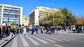 Photo of people crossing the crosswalk between the Ermou pedestrian street and Syntagma Square.