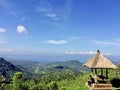 Photo of a person enjoy the view of the hill