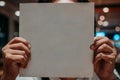 Photo of a person holding a blank white book for mock up and for commercial purposes Royalty Free Stock Photo