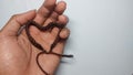 a photo of a person holding a heart-shaped brown bracelet Royalty Free Stock Photo