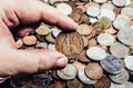 Photo of a person's hand holding a british coin